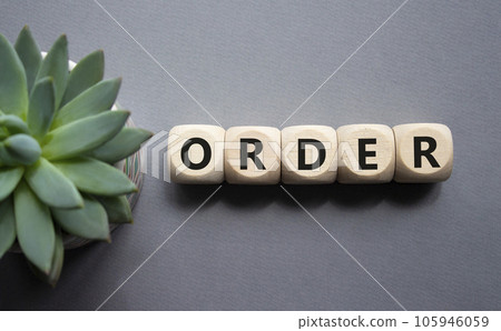 Order symbol. Wooden cubes with word Order. Beautiful grey background with succulent plant. Business and Order concept. Copy space. Order symbol. Wooden cubes with word Order. Beautiful grey background with succulent plant. Business and Order concept. Copy space. 105946059