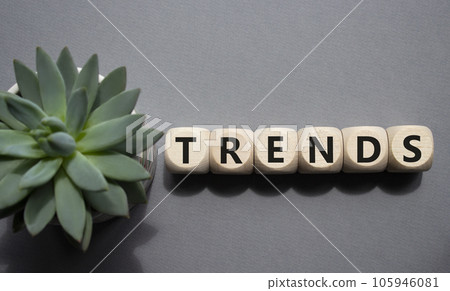Trends symbol. Concept word Trends on wooden cubes. Beautiful grey background. Business and Trends concept. Copy space. Trends symbol. Concept word Trends on wooden cubes. Beautiful grey background. Business and Trends concept. Copy space. 105946081