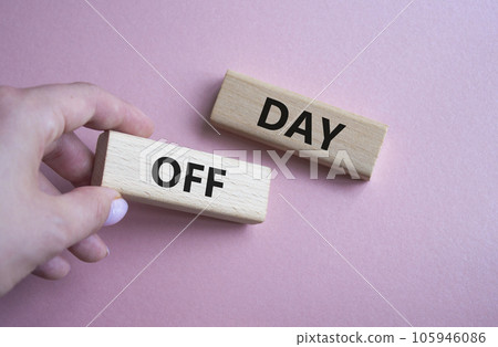 Day off symbol. Concept word Day off on wooden blocks. Businessman hand. Beautiful pink background. Business and Day off concept. Copy space 105946086