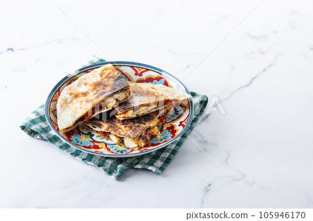 Mexican chicken quesadillas with cheese and peppers on white marble 105946170