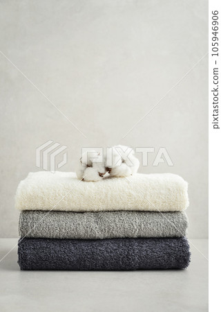 Stack of bath towels with cotton flowers Stack of bath towels with cotton flowers 105946906