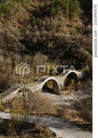 View of the traditional stone Kalogeriko or Plakida Bridge 105946976