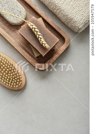 Natural soap bars, wheat spikelet and pumice stone on wooden tray Natural soap bars, wheat spikelet and pumice stone on wooden tray 105947579