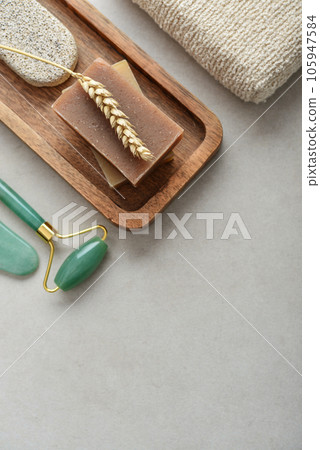 Natural soap bars, wheat spikelet and pumice stone on wooden tray Natural soap bars, wheat spikelet and pumice stone on wooden tray 105947584