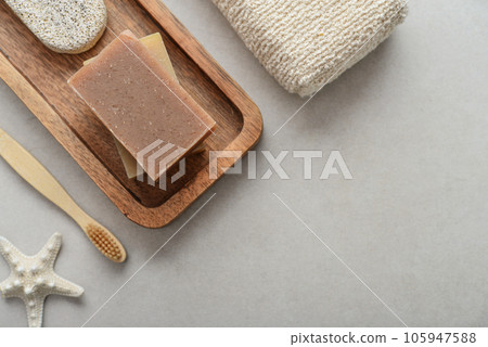Natural soap bars and pumice stone on wooden tray Natural soap bars and pumice stone on wooden tray 105947588