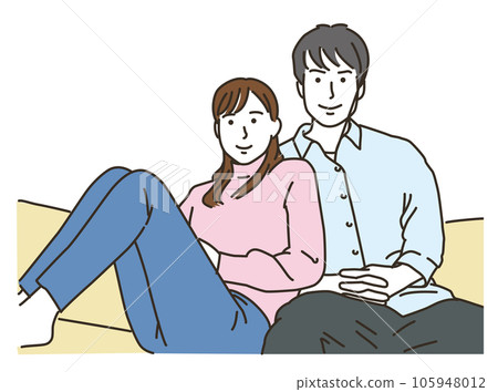 Couple cuddling on sofa indoors 105948012