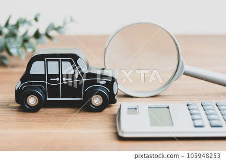 Toy car, calculator and magnifying glass on the table Toy car, calculator and magnifying glass on the table 105948253
