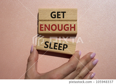 Get enough sleep symbol. Wooden blocks with words Get enough sleep. Beautiful pink background. Doctors hand. Healthy lifestyle, medical and Get enough sleep concept. Copy space. 105948337