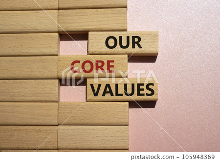 Our core values symbol. Concept words Our core values on wooden blocks. Beautiful pink background. Business and Our core values concept. Copy space. 105948369