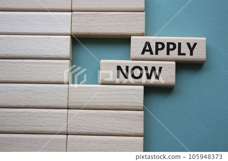 Apply now symbol. Concept word Apply now on wooden blocks. Beautiful grey green background. Business and Apply now concept. Copy space 105948373