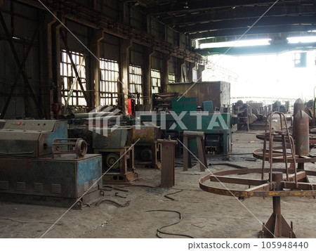 Production crisis, view of an abandoned factory shop. Disassembled Metalworking machines in an abandoned factory, close-up. 105948440