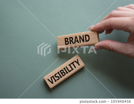 Brand visibility symbol. Wooden blocks with words Brand visibility. Beautiful grey green background. Businessman hand. Business and Brand visibility concept. Copy space. Brand visibility symbol. Wooden blocks with words Brand visibility. Beautiful grey green background. Businessman hand. Business and Brand visibility concept. Copy space. 105948456