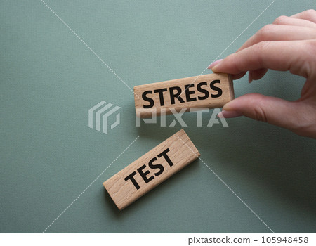 Stress test symbol. Wooden blocks with words Stress test. Beautiful grey green background. Businessman hand. Business and Stress test concept. Copy space. 105948458