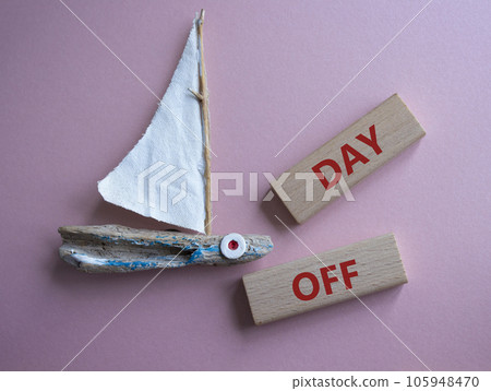 Day off symbol. Concept word Day off on wooden blocks. Beautiful pink background. Business and Day off concept. Copy space Day off symbol. Concept word Day off on wooden blocks. Beautiful pink background. Business and Day off concept. Copy space 105948470
