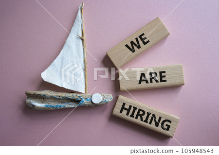 We are Hiring symbol. Concept words We are Hiring on wooden blocks. Beautiful pink background with boat. Business and We are Hiring concept. Copy space. We are Hiring symbol. Concept words We are Hiring on wooden blocks. Beautiful pink background with boat. Business and We are Hiring concept. Copy space. 105948543