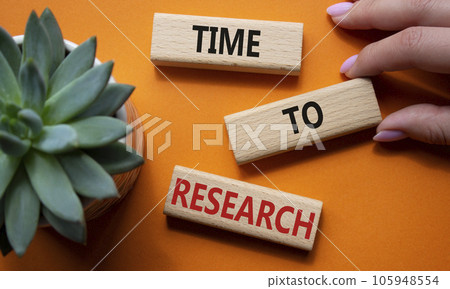 Time to Research symbol. Concept word Time to Research on wooden blocks. Businessman hand. Beautiful orange background. Business and Time to Research concept. Copy space 105948554