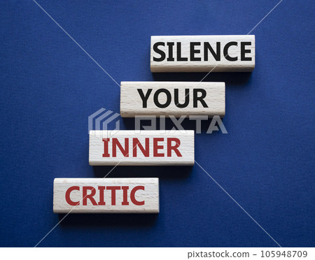 Silence your inner critic symbol. Wooden blocks with words Silence your inner critic. Beautiful deep blue background. Business and Silence your inner critic concept. Copy space. 105948709