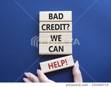 Bad credit We can Help symbol. Wooden blocks with words Bad credit We can Help. Beautiful deep blue background. Businessman hand. Business and Bad credit We can Help concept. Copy space. 105948719