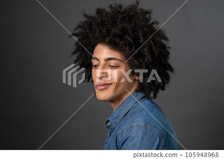 Curly-haired young guy smirking and looking foxy Curly-haired young guy smirking and looking foxy 105948968
