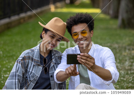 Smiling couple making selfie in the park 105949089