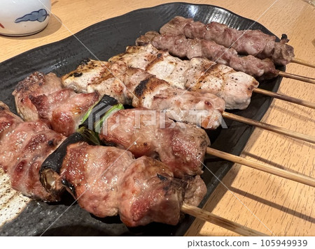 Assorted grilled chicken on a black plate Assorted grilled chicken on a black plate 105949939