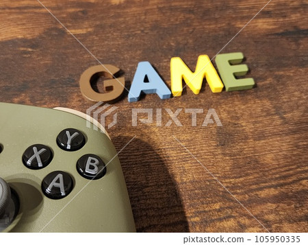 The controller and GAME characters on the desk 105950335