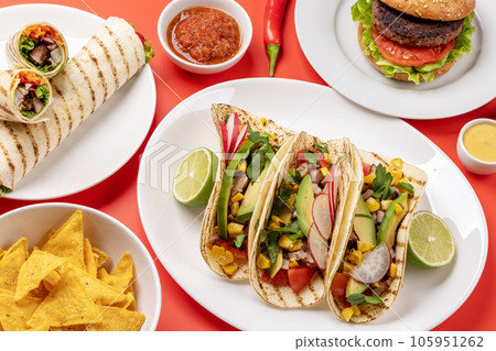 Mexican food featuring tacos, burritos, nachos, burgers Mexican food featuring tacos, burritos, nachos, burgers 105951262