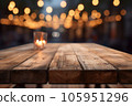 Wooden table with candle lantern on blurred evening lights abstract background 105951296
