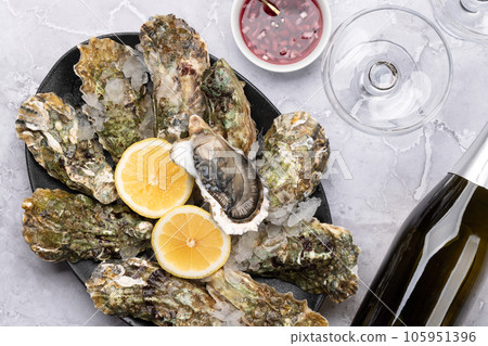 Fresh oysters with glasses of sparkling wine Fresh oysters with glasses of sparkling wine 105951396