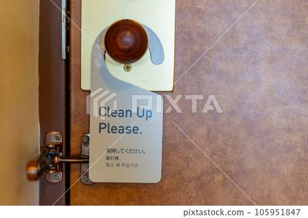 Hotel doorknob with "Clean Up Please" plaque 105951847