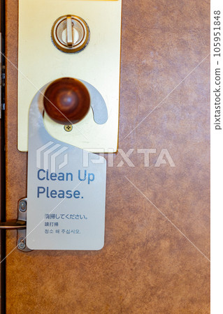 Hotel doorknob with "Clean Up Please" plaque 105951848