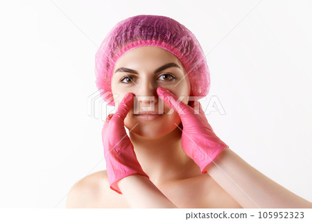Young woman doing cosmetological injection on face against white studio background. Massage 105952323