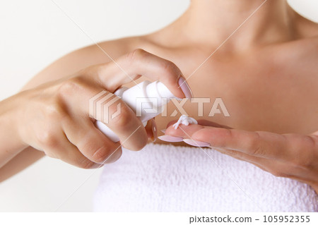 Cropped image of female hands applying face cream, taking care after skin after shower. Home spa Cropped image of female hands applying face cream, taking care after skin after shower. Home spa 105952355