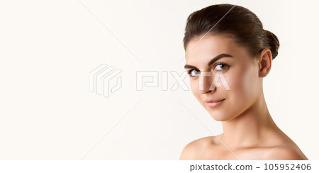 Beautiful young woman with well-kept healthy skin, brown hair and eyes looking at camera against white studio background 105952406