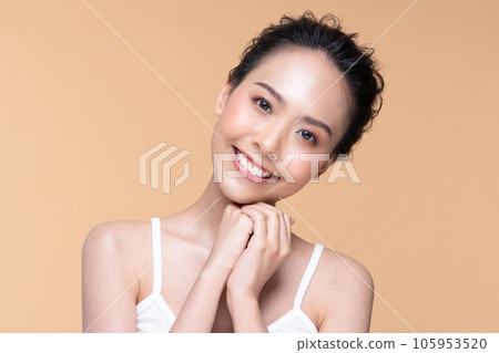 Beautiful Asian young woman touching soft cheek smile with clean fresh skin Happiness and cheerful with positive emotional,isolated on Beige background,Beauty Cosmetics and Facial treatment Concept Beautiful Asian young woman touching soft cheek smile with clean fresh skin Happiness and cheerful with positive emotional,isolated on Beige background,Beauty Cosmetics and Facial treatment Concept 105953520