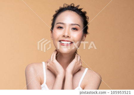 Beautiful Asian young woman touching soft cheek smile with clean fresh skin Happiness and cheerful with positive emotional,isolated on Beige background,Beauty Cosmetics and Facial treatment Concept Beautiful Asian young woman touching soft cheek smile with clean fresh skin Happiness and cheerful with positive emotional,isolated on Beige background,Beauty Cosmetics and Facial treatment Concept 105953521
