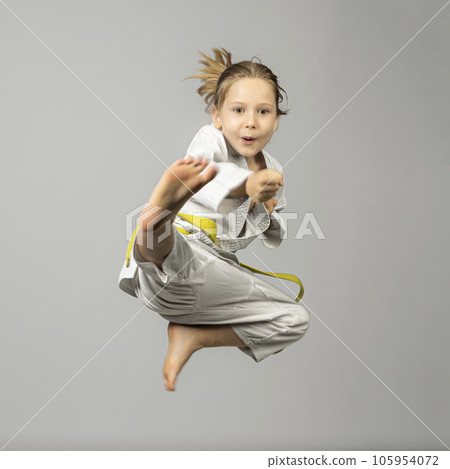 girl performs martial arts flying kick girl performs martial arts flying kick 105954072