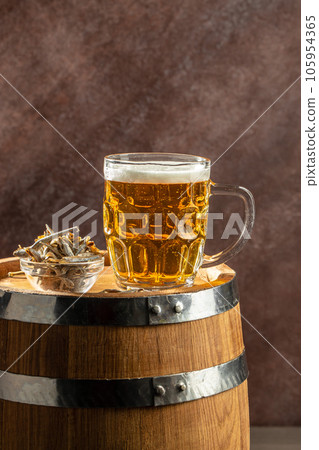 glass beer with dried fish snack. Beer brewery concept. Snack for beer dried smelts. Beer background 105954365