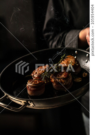 beef tenderloin steak is grilled in a grill pan with steaming. vertical image. top view. place for text 105954404