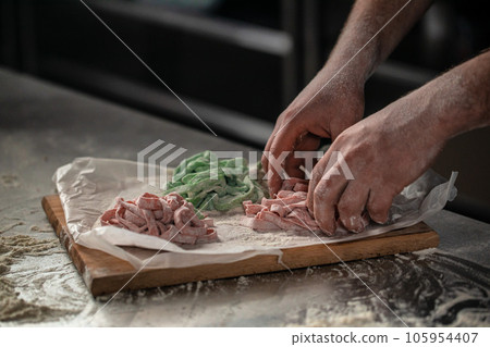 Raw homemade pasta, preparing pasta, home cooking concept 105954407