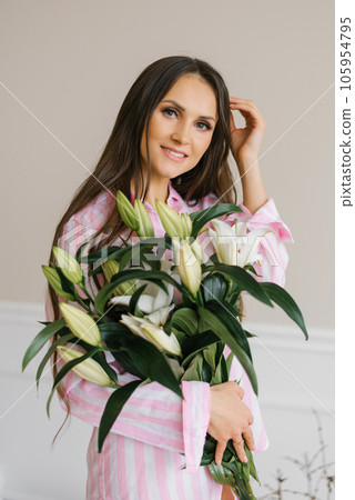 Portrait of a beautiful caucasian woman in her thirties with a bouquet of white lilies Portrait of a beautiful caucasian woman in her thirties with a bouquet of white lilies 105954795