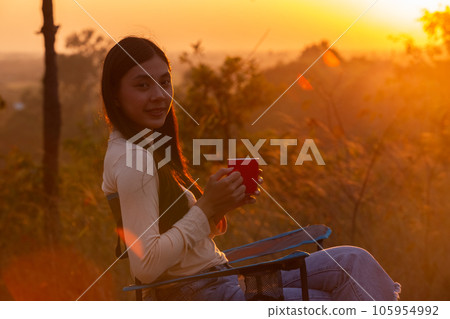 Female enjoys scenery mountains view drinking coffee. woman traveler with view landscape. Female enjoys scenery mountains view drinking coffee. woman traveler with view landscape. 105954992