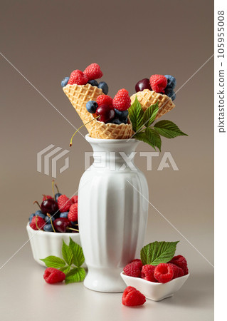 Fresh berries in waffle cones. 105955008