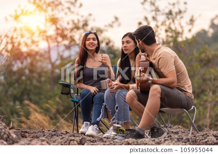man and two women three people happy together, picnic in forest, man and two women three people happy together, picnic in forest, 105955044