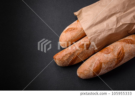French baguette bread on a dark textured concrete background 105955333