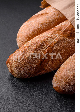 French baguette bread on a dark textured concrete background 105955338