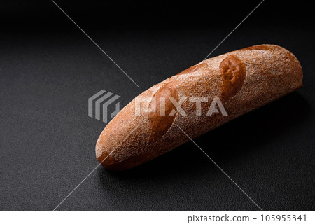 French baguette bread on a dark textured concrete background 105955341