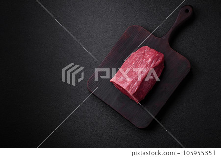 Juicy fresh raw beef meat with salt, spices and herbs Juicy fresh raw beef meat with salt, spices and herbs 105955351