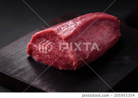 Juicy fresh raw beef meat with salt, spices and herbs Juicy fresh raw beef meat with salt, spices and herbs 105955354