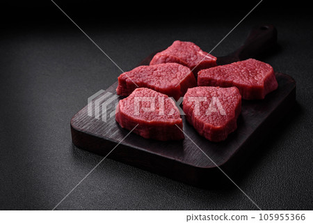 Juicy fresh raw beef meat with salt, spices and herbs Juicy fresh raw beef meat with salt, spices and herbs 105955366